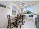 Bright dining area featuring a dark wood table, chandelier, and sliding glass doors to the outdoor patio at 9115 Longship Aly, Orlando, FL 32832