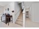 Bright entryway features tile flooring, staircase, and a built-in bar with seating, leading to a hallway and laundry area at 9115 Longship Aly, Orlando, FL 32832