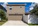 Two-story home with a two-car garage and a well-maintained front yard with room for parking at 9115 Longship Aly, Orlando, FL 32832