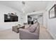 Cozy living room with neutral carpet, TV, open floor plan and modern lighting at 9115 Longship Aly, Orlando, FL 32832