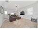 Bright living room featuring neutral carpet, TV, modern lighting and furniture at 9115 Longship Aly, Orlando, FL 32832
