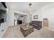Living room with neutral carpet, modern coffee table, and open access to the kitchen at 9115 Longship Aly, Orlando, FL 32832
