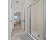 Bathroom with a large glass enclosed standing shower and a door to the bedroom in the background at 9115 Longship Aly, Orlando, FL 32832