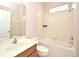 Bright bathroom with a tiled shower and tub combination and a wood vanity at 9223 Leeland Archer Blvd, Orlando, FL 32836