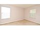Carpeted bedroom featuring neutral paint, base trim and natural light from two windows at 9223 Leeland Archer Blvd, Orlando, FL 32836