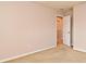 This carpeted bedroom features neutral paint, base trim and ample natural light at 9223 Leeland Archer Blvd, Orlando, FL 32836