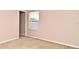 Cozy bedroom featuring carpeted floors and natural light from a window at 9223 Leeland Archer Blvd, Orlando, FL 32836