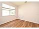 Neutral bedroom with wood floors and a large window providing natural light at 9223 Leeland Archer Blvd, Orlando, FL 32836