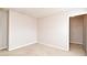 Carpeted bedroom with a bright, open closet and fresh, neutral paint at 9223 Leeland Archer Blvd, Orlando, FL 32836