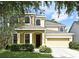 Charming two-story home featuring a well-manicured lawn and attached two car garage at 9223 Leeland Archer Blvd, Orlando, FL 32836