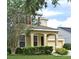Inviting two-story home with an attached garage and manicured green lawn at 9223 Leeland Archer Blvd, Orlando, FL 32836