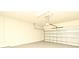 Empty two car garage with smooth concrete flooring and automatic door at 9223 Leeland Archer Blvd, Orlando, FL 32836