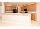 Bright kitchen showcases wood cabinets, black appliances, a breakfast bar, and tile flooring at 9223 Leeland Archer Blvd, Orlando, FL 32836