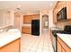 Traditional kitchen featuring wood cabinetry, black appliances, tile floors, and recessed lighting at 9223 Leeland Archer Blvd, Orlando, FL 32836