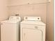 Laundry room with washer and dryer and shelf overhead for storage at 9223 Leeland Archer Blvd, Orlando, FL 32836