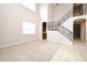 Spacious living room with high ceilings and staircase with iron railing at 9223 Leeland Archer Blvd, Orlando, FL 32836