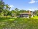 Expansive backyard with mature trees and screened-in porch at 1008 Bay Ave, Lake Wales, FL 33859