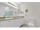 Bathroom with dual sinks, white vanity, and a toilet at 1008 Bay Ave, Lake Wales, FL 33859
