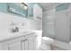 Bathroom features white vanity with sink, shower with sliding door, and tiled walls at 1008 Bay Ave, Lake Wales, FL 33859