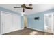 Bedroom featuring blue walls, ceiling fan, closet, and en suite bathroom at 1008 Bay Ave, Lake Wales, FL 33859