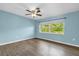 Bedroom with blue walls, wood flooring, and a ceiling fan at 1008 Bay Ave, Lake Wales, FL 33859