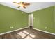 Bedroom featuring green walls, wood-look flooring, and an open doorway at 1008 Bay Ave, Lake Wales, FL 33859