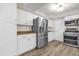 Well-lit kitchen with stainless steel refrigerator, white cabinets, and modern appliances at 1008 Bay Ave, Lake Wales, FL 33859