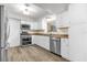 Updated kitchen with stainless steel appliances, white cabinets, and modern design elements at 1008 Bay Ave, Lake Wales, FL 33859