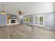 Open-concept living room with fireplace and access to the patio at 1008 Bay Ave, Lake Wales, FL 33859