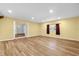 Spacious living room featuring light wood floors, neutral walls, and a bright window at 1008 Bay Ave, Lake Wales, FL 33859