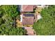 A direct overhead view reveals a home with solar panels and lush landscaping, nestled among trees at 1039 Eagles Forrest Dr, Apopka, FL 32712