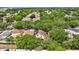 An aerial view shows a home surrounded by mature trees in a residential neighborhood at 1039 Eagles Forrest Dr, Apopka, FL 32712