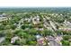An aerial view shows a home with solar panels surrounded by mature trees in a residential neighborhood at 1039 Eagles Forrest Dr, Apopka, FL 32712