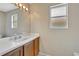 Bathroom featuring a single sink vanity, large mirror, and natural light at 1039 Eagles Forrest Dr, Apopka, FL 32712