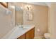 Bathroom with vanity, toilet, mirror and lighting at 1039 Eagles Forrest Dr, Apopka, FL 32712