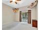 Bedroom with carpet and slider leading to backyard at 1039 Eagles Forrest Dr, Apopka, FL 32712