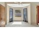 Sunny breakfast nook with light wood cabinets, tiled floor, and a large window framed by blue curtains at 1039 Eagles Forrest Dr, Apopka, FL 32712