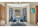 Bright breakfast nook with white table, blue chairs, bay window, and elegant curtains, creating a cozy dining space at 1039 Eagles Forrest Dr, Apopka, FL 32712