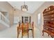 Dining room with tile floors and high ceilings, featuring a wooden dining table and chest of drawers at 1039 Eagles Forrest Dr, Apopka, FL 32712