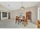 Dining room with tile floors and high ceilings, featuring a wooden dining table and chest of drawers at 1039 Eagles Forrest Dr, Apopka, FL 32712