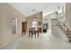 Dining room featuring tile flooring, a staircase, neutral walls, and a wooden dining table at 1039 Eagles Forrest Dr, Apopka, FL 32712