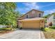 Charming two-story home with a stone-accented front, a two-car garage, and a well-manicured lawn at 1039 Eagles Forrest Dr, Apopka, FL 32712