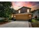 Charming two-story home with a stone-accented front, a two-car garage, and a well-manicured lawn at 1039 Eagles Forrest Dr, Apopka, FL 32712