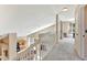 Upstairs hallway with carpet flooring overlooking the kitchen and living area at 1039 Eagles Forrest Dr, Apopka, FL 32712