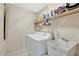 Functional laundry room with washer, dryer, shelving, and utility sink for added convenience at 1039 Eagles Forrest Dr, Apopka, FL 32712