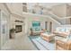 Bright and airy living room featuring a fireplace, vaulted ceilings, a staircase, and cozy wicker furniture at 1039 Eagles Forrest Dr, Apopka, FL 32712
