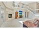 Spacious living room with a fireplace, vaulted ceilings, a staircase, and neutral décor creating a comfortable ambiance at 1039 Eagles Forrest Dr, Apopka, FL 32712