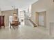 Open-concept living room showcasing a staircase, high ceilings, tile floors, and dining area at 1039 Eagles Forrest Dr, Apopka, FL 32712