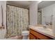 Bathroom featuring a shower curtain and neutral fixtures providing an essential, clean bathroom area at 1128 Travertine Ter, Sanford, FL 32771