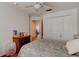 Bedroom with hardwood floor and ceiling fan; bedroom flows into hallway at 1128 Travertine Ter, Sanford, FL 32771